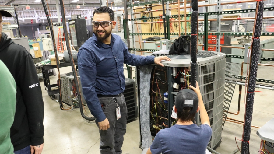Two students managing an air conditioning machine