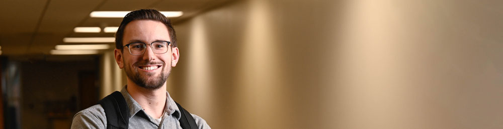 Smiling student in a hallway