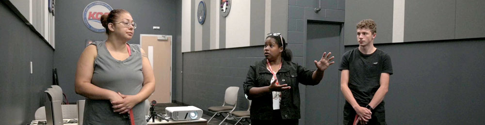 Instructor speaking with two students