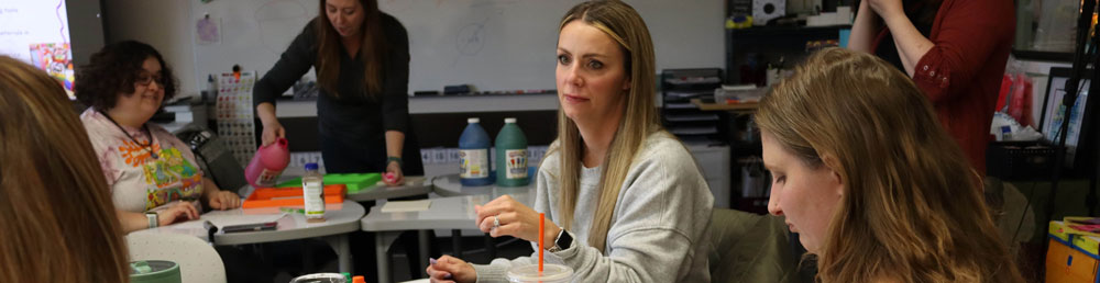 Students in a classroom working on a craft project