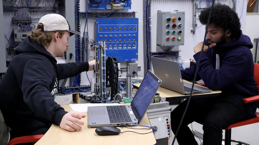 Two students on their laptops