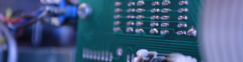 A circuit board with wires in the background