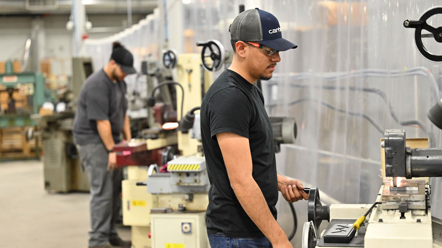 Two students working on surface grinders