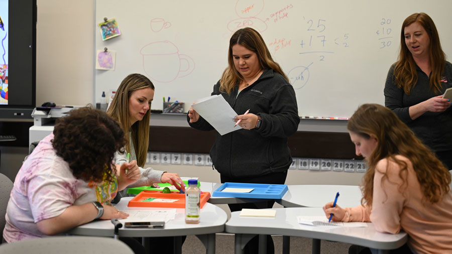 Four students working at a classroom table