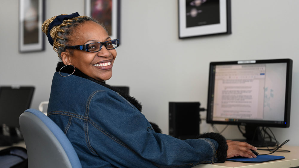 Smiling student working at a computer