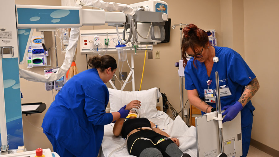 Students doing hands-on training with radiography equipment