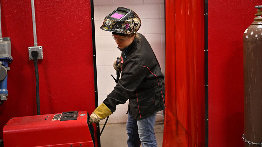 Student adjusting a TIG welder