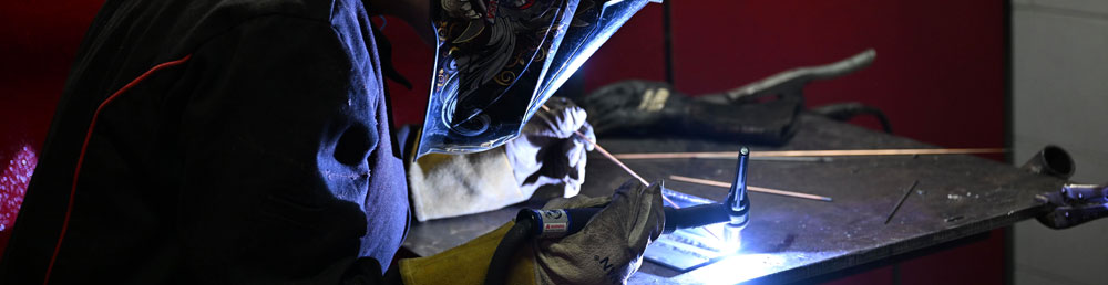 Student welding on a TIG welder