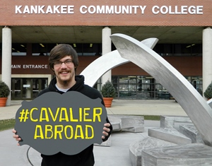 Zack Rupp holding a '#CAVALIER ABROAD' sign