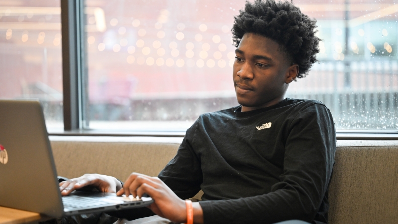 A student studying in the lounge area in the college center.