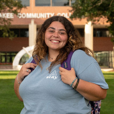 Adriana Lowery-Garcia wearing a purple backpack in the Riverfront Campus courtyard