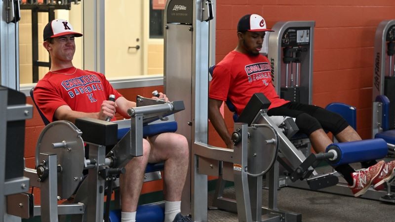 Two athletes working out inside the Fitness Center
