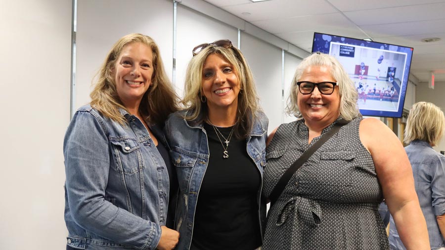 Group of three smiling at the Lady Cavs reunion.