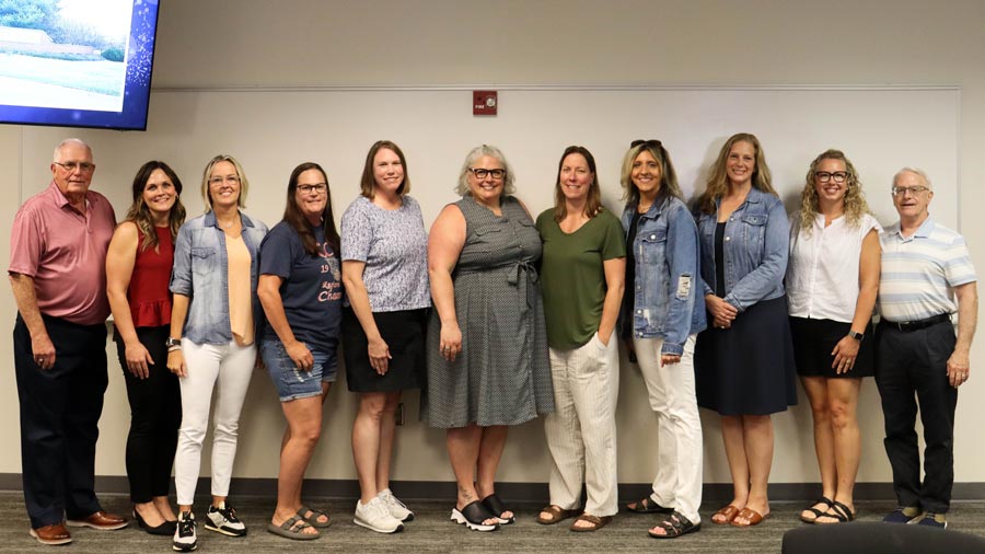 Nine former Lady Cavs posing with two former coaches for a group photo at the Lady Cavs reunion.