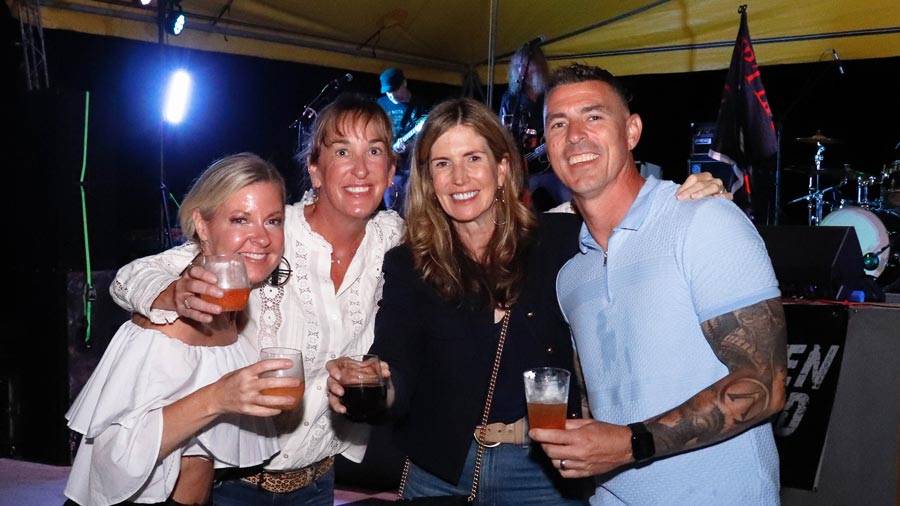 A group of four smiling at the Let's Party! annual fundraiser