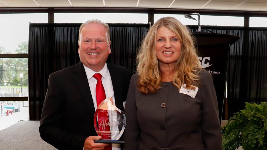 Two people smiling at the scholarship luncheon.