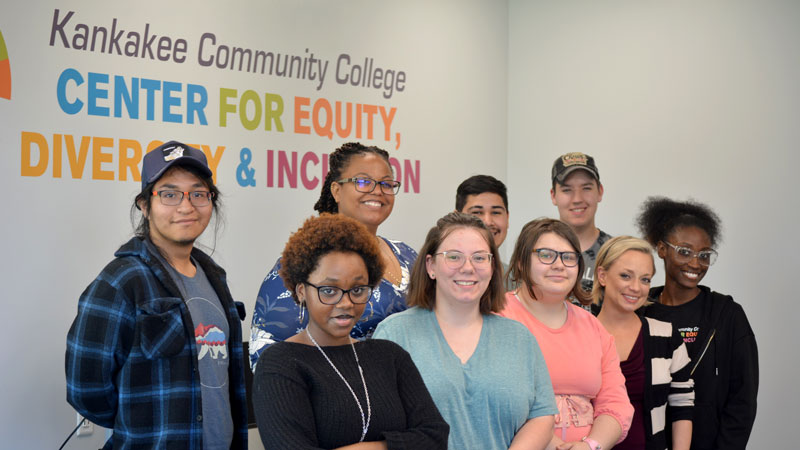Christa Agee and eight students posing for a group photo in the Center for Equity, Diversity and Inclusion