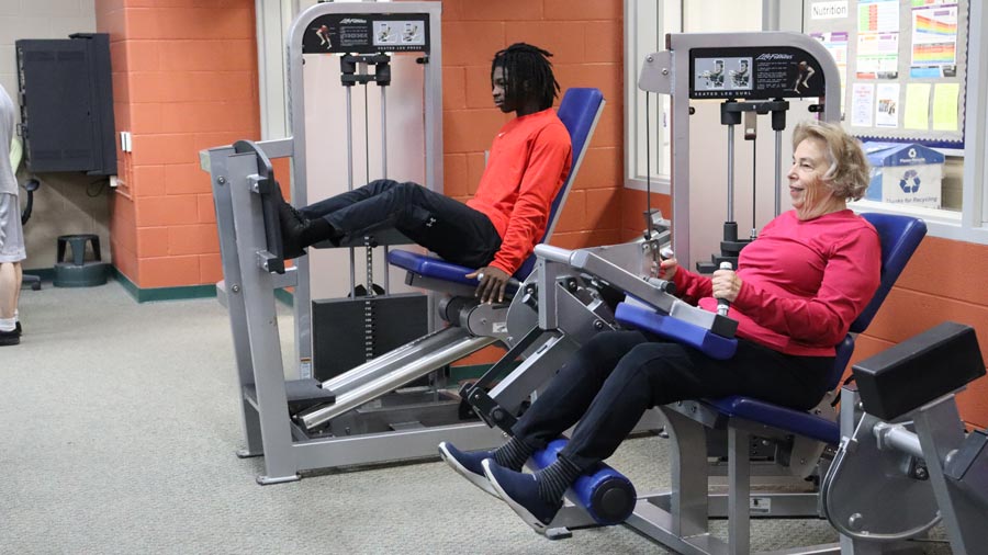 Two individuals using exercise equipment